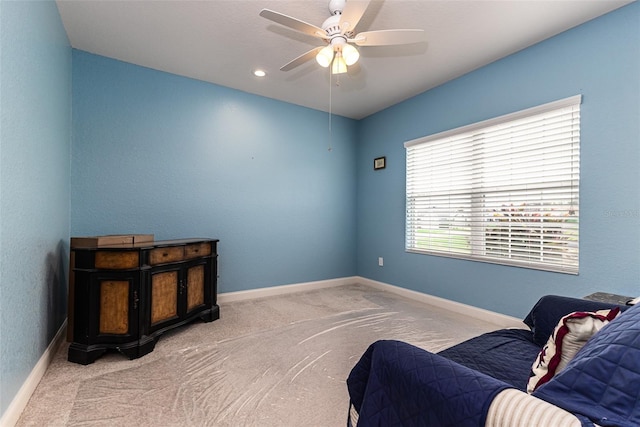 sitting room featuring ceiling fan and light colored carpet