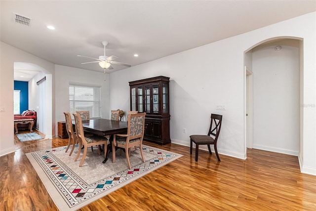 dining space with light hardwood / wood-style floors and ceiling fan