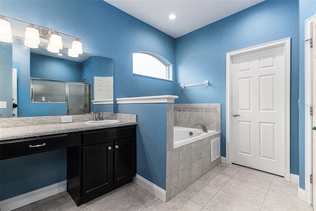 bathroom featuring vanity, independent shower and bath, and tile patterned floors