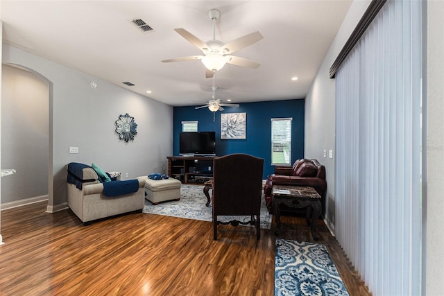 living room featuring wood-type flooring and ceiling fan