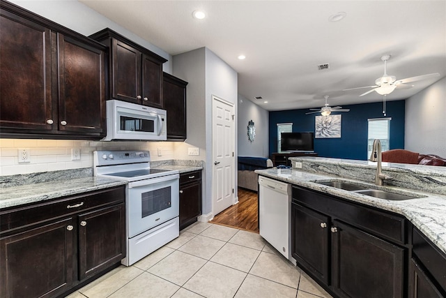 kitchen with sink, ceiling fan, light tile patterned floors, white appliances, and dark brown cabinets