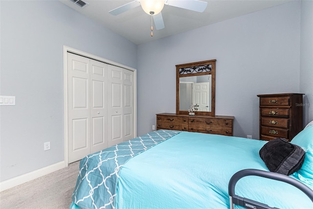 carpeted bedroom with ceiling fan and a closet