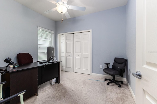 carpeted office space featuring ceiling fan