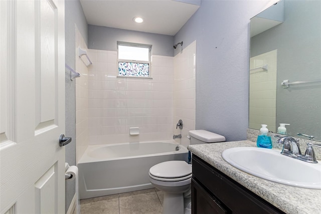 full bathroom featuring tile patterned floors, vanity, tiled shower / bath combo, and toilet