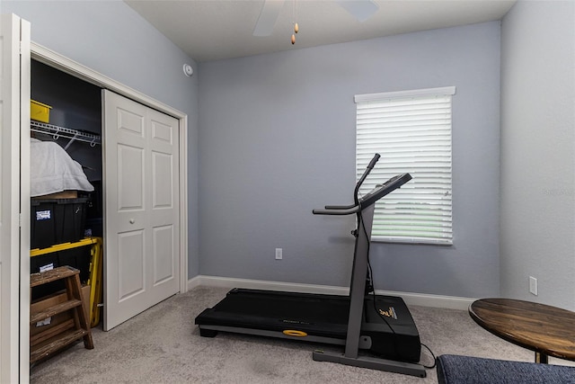 exercise room featuring light carpet and ceiling fan