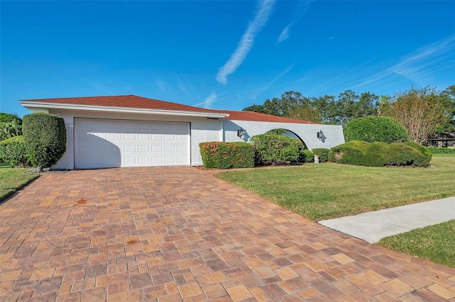 ranch-style house with a garage and a front yard