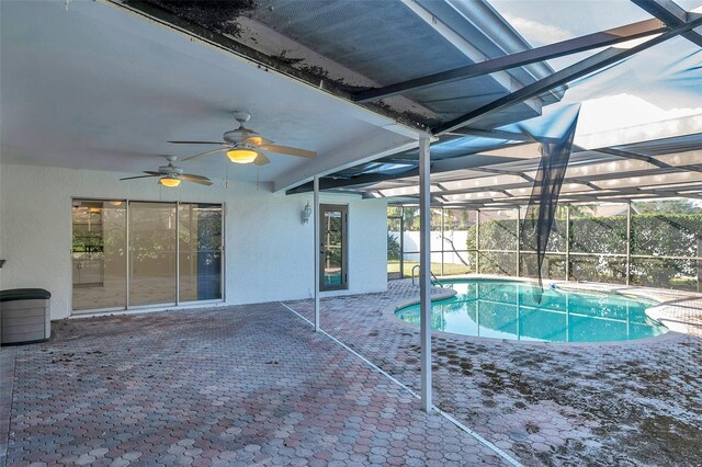 view of swimming pool featuring a lanai, ceiling fan, and a patio