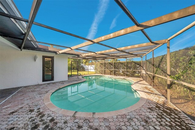 view of pool with a patio and a lanai