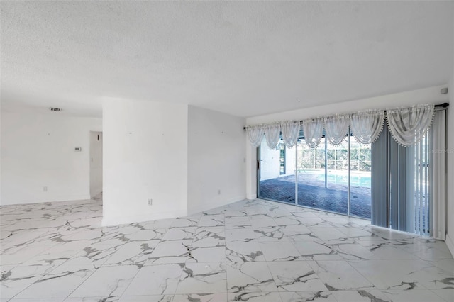 empty room featuring a textured ceiling