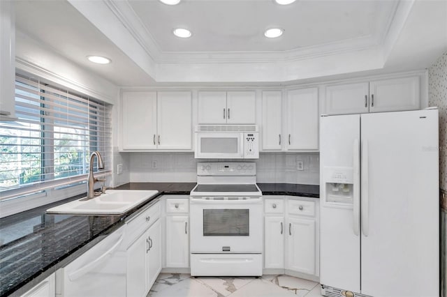 kitchen with white appliances, white cabinetry, sink, and a raised ceiling