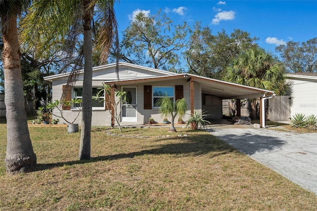 view of front of house featuring covered porch, a front lawn, and a carport