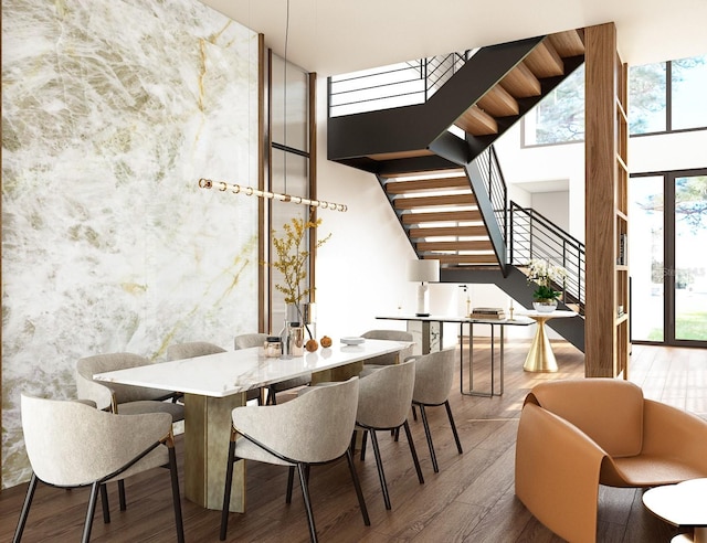 dining room featuring hardwood / wood-style floors and a high ceiling