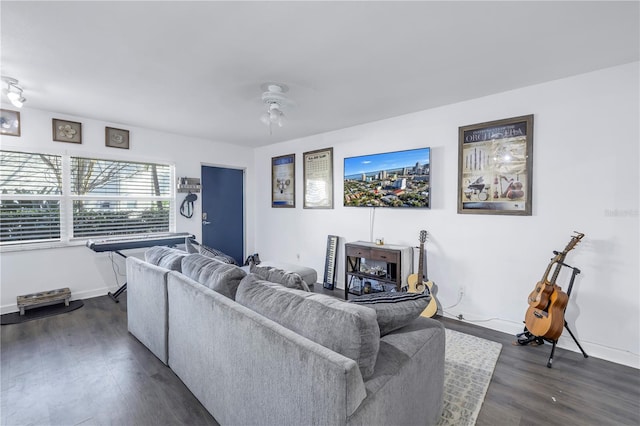 living room with dark wood-type flooring and ceiling fan