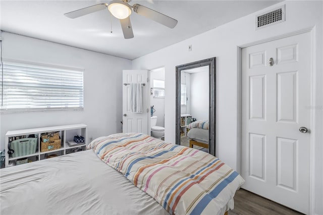 bedroom with connected bathroom, ceiling fan, and dark hardwood / wood-style floors