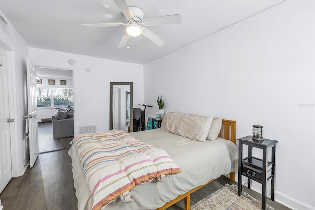 bedroom with ceiling fan and dark hardwood / wood-style flooring