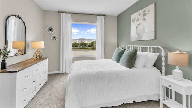 bedroom featuring light colored carpet