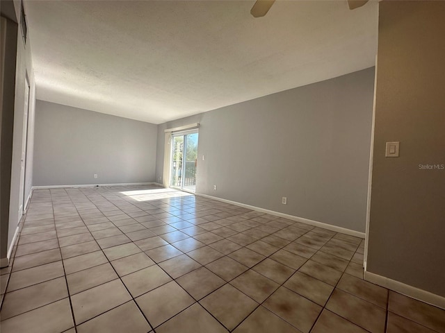 tiled spare room with ceiling fan and a textured ceiling