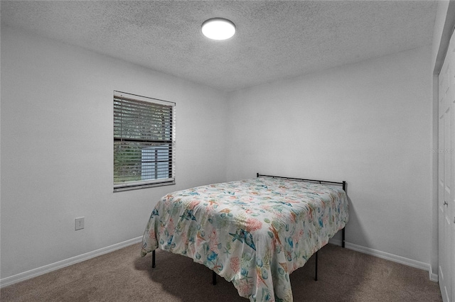 carpeted bedroom featuring a textured ceiling