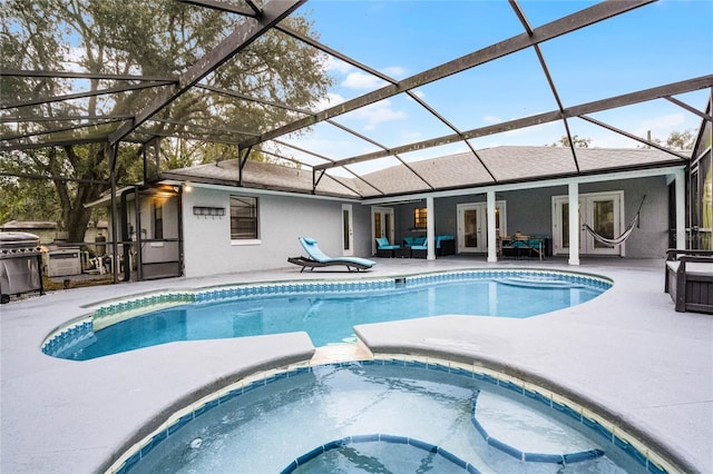 view of pool with a lanai, a patio area, an outdoor hangout area, and grilling area