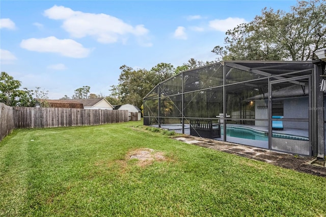 view of yard with a lanai and a fenced in pool