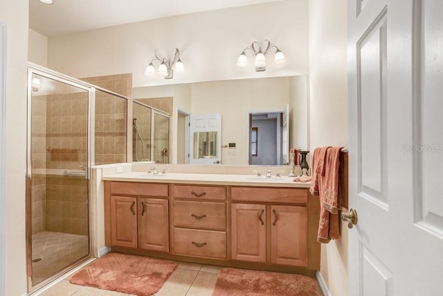 bathroom with vanity, tile patterned floors, and a shower with door