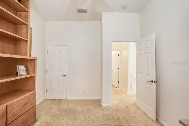 unfurnished bedroom with light colored carpet