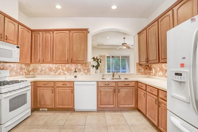 kitchen featuring light tile patterned flooring, white appliances, sink, and ceiling fan