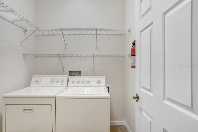 washroom with washing machine and clothes dryer