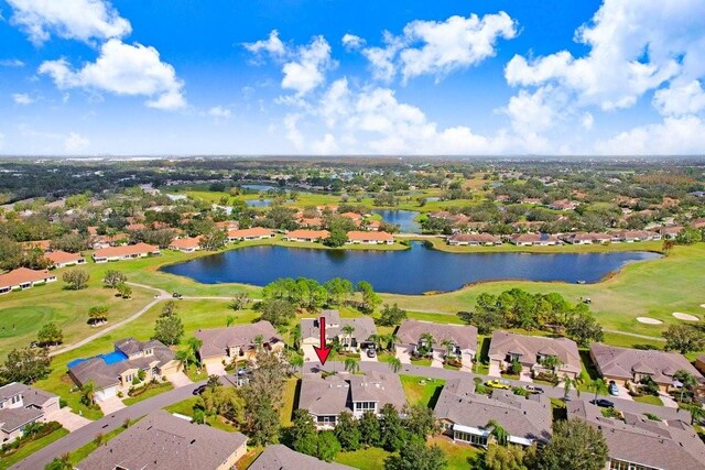 birds eye view of property with a residential view, view of golf course, and a water view