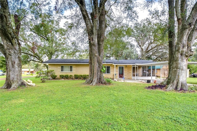 single story home featuring a front yard and a sunroom