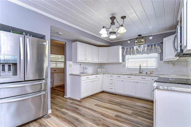 kitchen with stainless steel appliances, white cabinets, light wood-type flooring, and ornamental molding