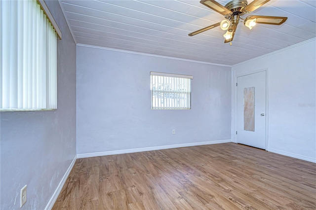 unfurnished room featuring hardwood / wood-style floors, ceiling fan, and crown molding