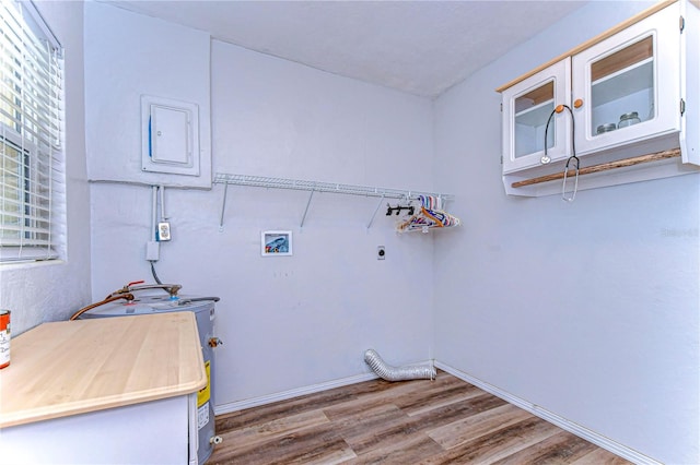 washroom featuring washer hookup, electric panel, hardwood / wood-style flooring, and hookup for an electric dryer