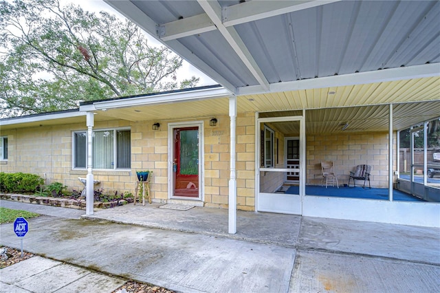 view of exterior entry featuring a patio