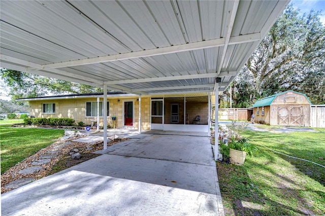 exterior space with a patio, a front yard, and a storage shed