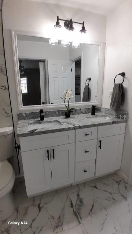 bathroom featuring vanity and toilet