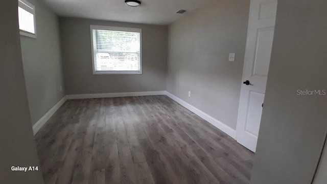 spare room with dark hardwood / wood-style flooring