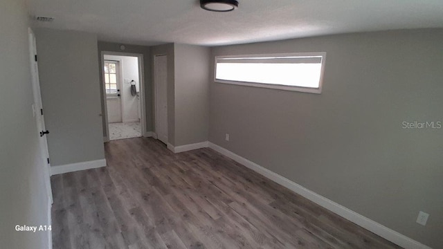 unfurnished bedroom with a closet and hardwood / wood-style flooring