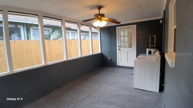 unfurnished sunroom with washer and dryer and ceiling fan