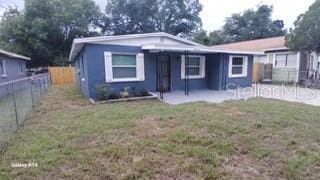 bungalow-style home with a patio, a front yard, and fence