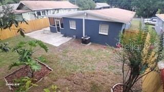 rear view of property featuring a patio and a fenced backyard