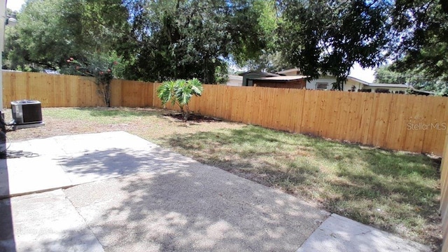 view of yard with central air condition unit, a patio, and a fenced backyard