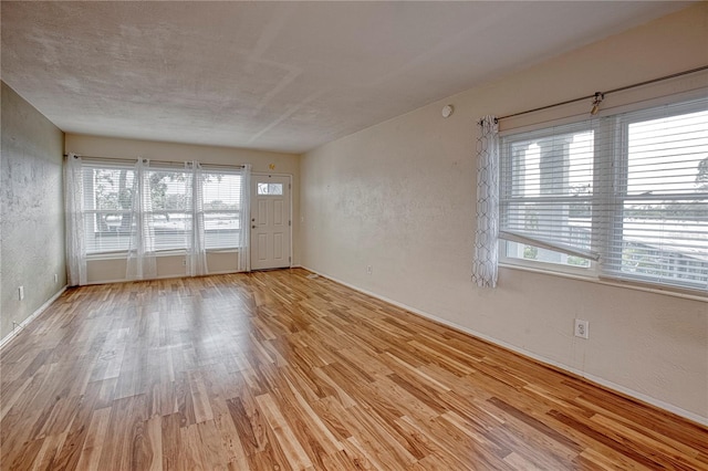 spare room with light hardwood / wood-style flooring