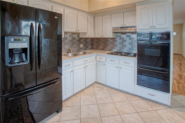 kitchen with light tile patterned flooring, white cabinetry, sink, black appliances, and tasteful backsplash