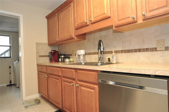 kitchen featuring dishwasher, sink, decorative backsplash, and light tile patterned floors