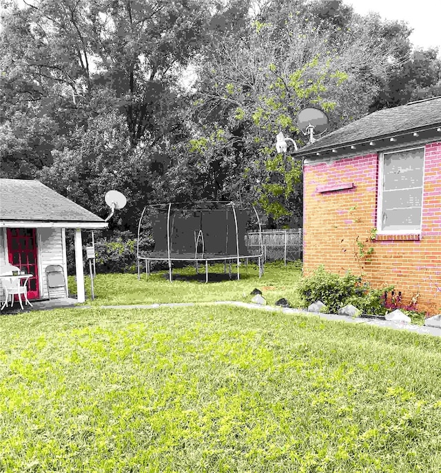 view of yard with a trampoline