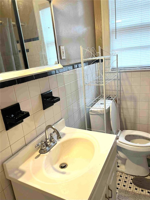 bathroom featuring tile walls, vanity, tile patterned floors, toilet, and decorative backsplash