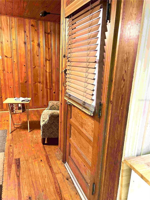 interior space featuring wooden walls and light wood-type flooring