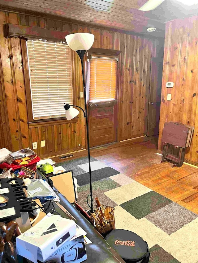 workout area featuring wood walls and wood-type flooring