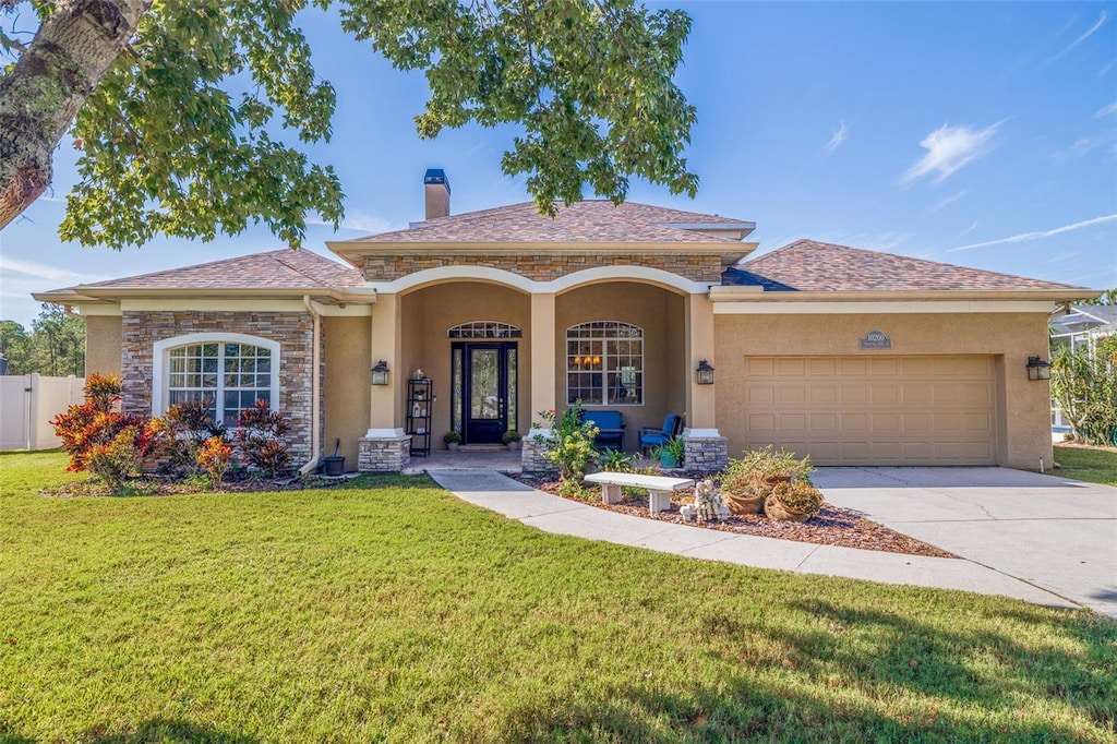 view of front facade featuring a garage and a front lawn